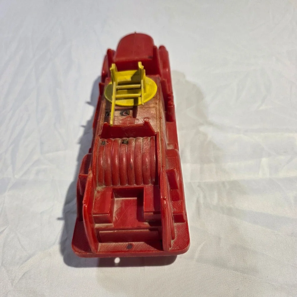 Vintage Red Plastic Fire Truck Toy with Rotating Yellow Ladder and Hose Reel